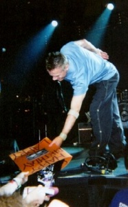 Photo of Larry Mullen accepting a 40th birthday card in Providence, October 2001